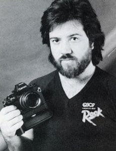 A man holding a camera in front of him.