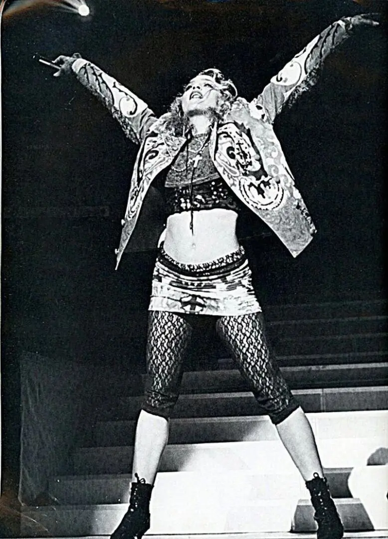 A woman in black and white outfit on stage.